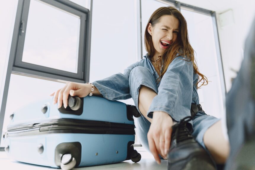 Cheerful young woman with luggage, highlighting Cebu Pacific Baggage Allowance travel tips