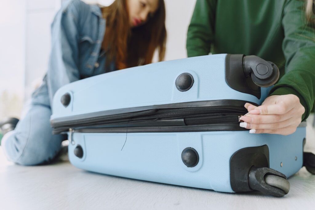 Two women packing a suitcase for Domestic Flights in the Philippines