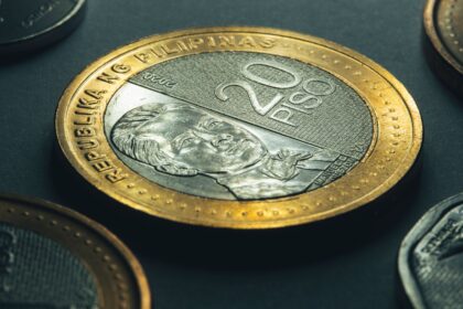 Gold and silver coins representing Philippines Currency and money exchange for travellers