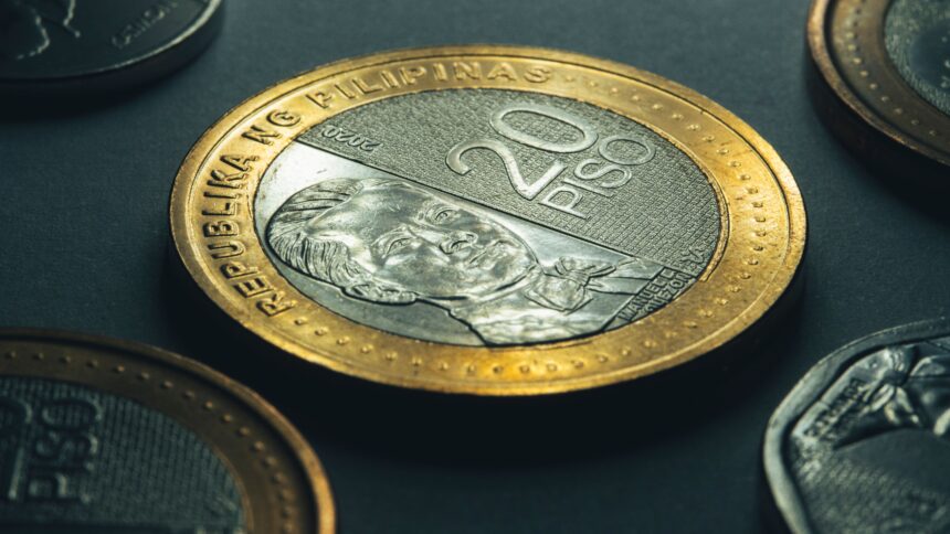 Gold and silver coins representing Philippines Currency and money exchange for travellers