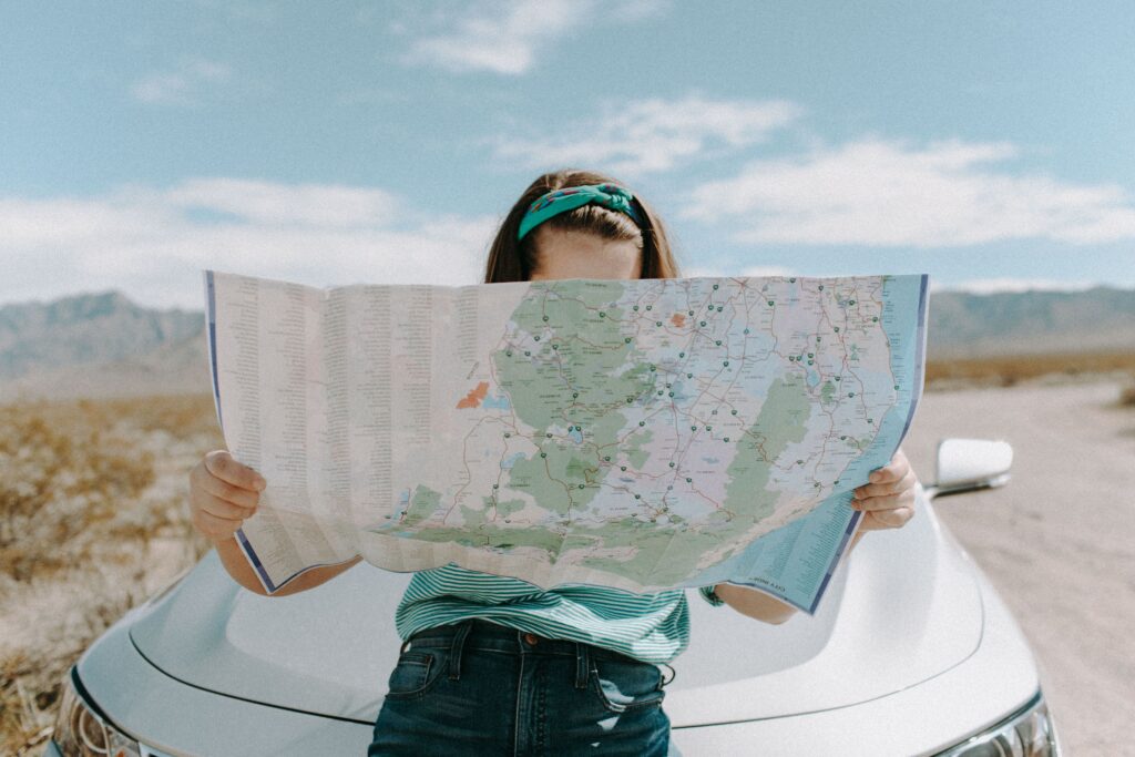 Young woman checking a map while planning Domestic Flights in the Philippines