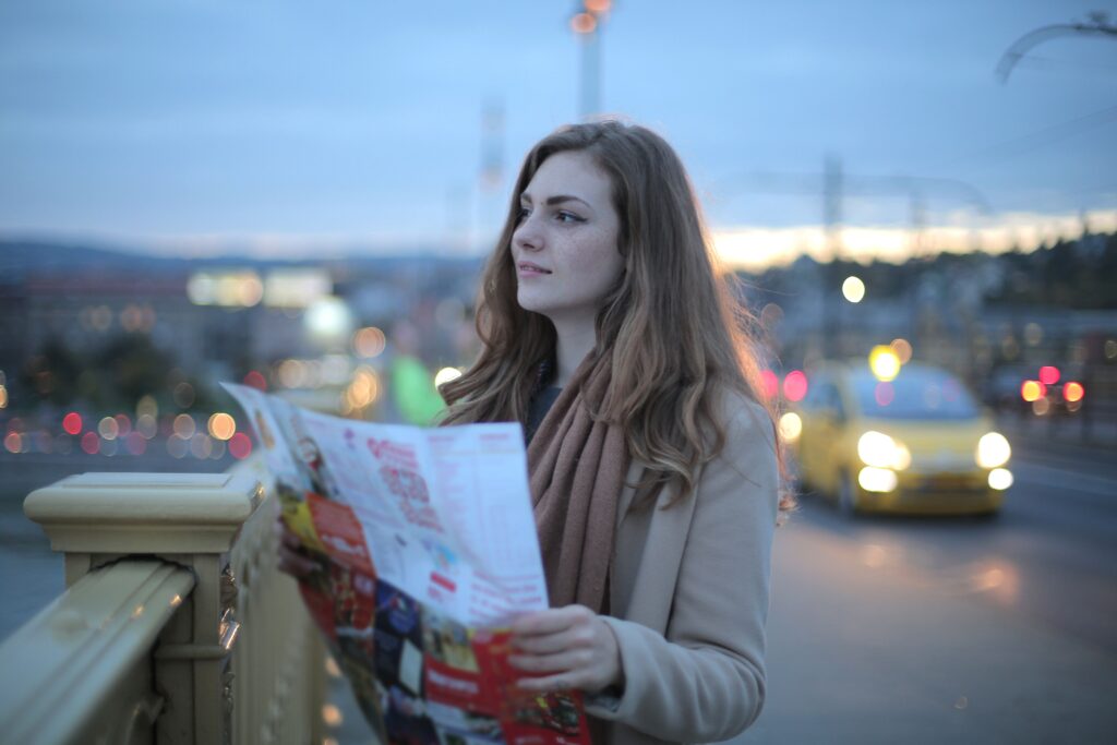 Young woman holding a map while planning how to get around the philippines