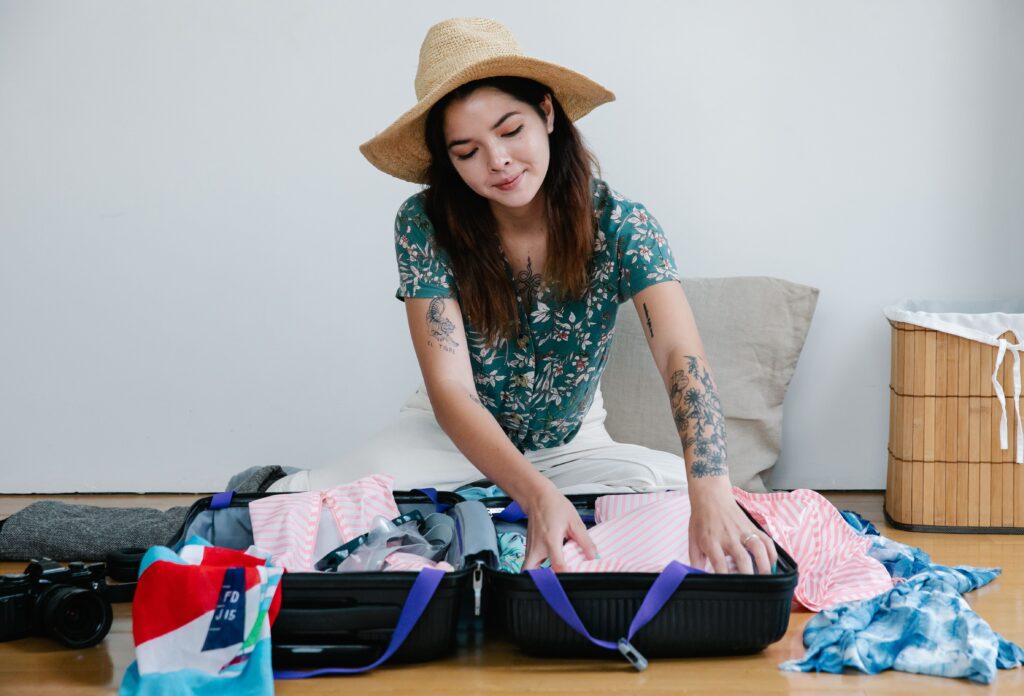 Woman packing a suitcase while preparing for a trip, with tips on Cebu Pacific Baggage Allowance